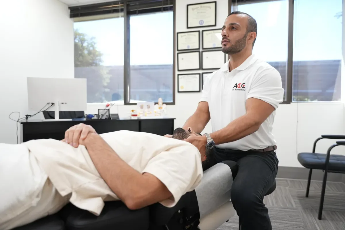 Dr. Milad Mandavi adjusting a patient at the Accident Center of California in Calabasas