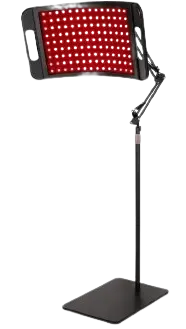 Standing infrared heat lamp positioned over a treatment table